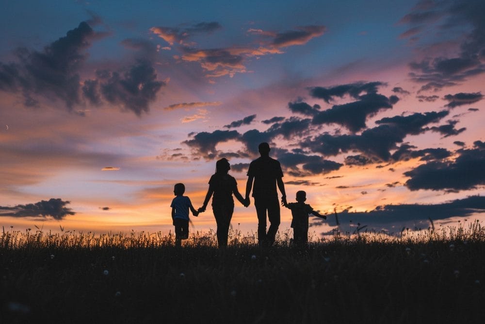 A familiy moving ahead in the distance and thinking of a future