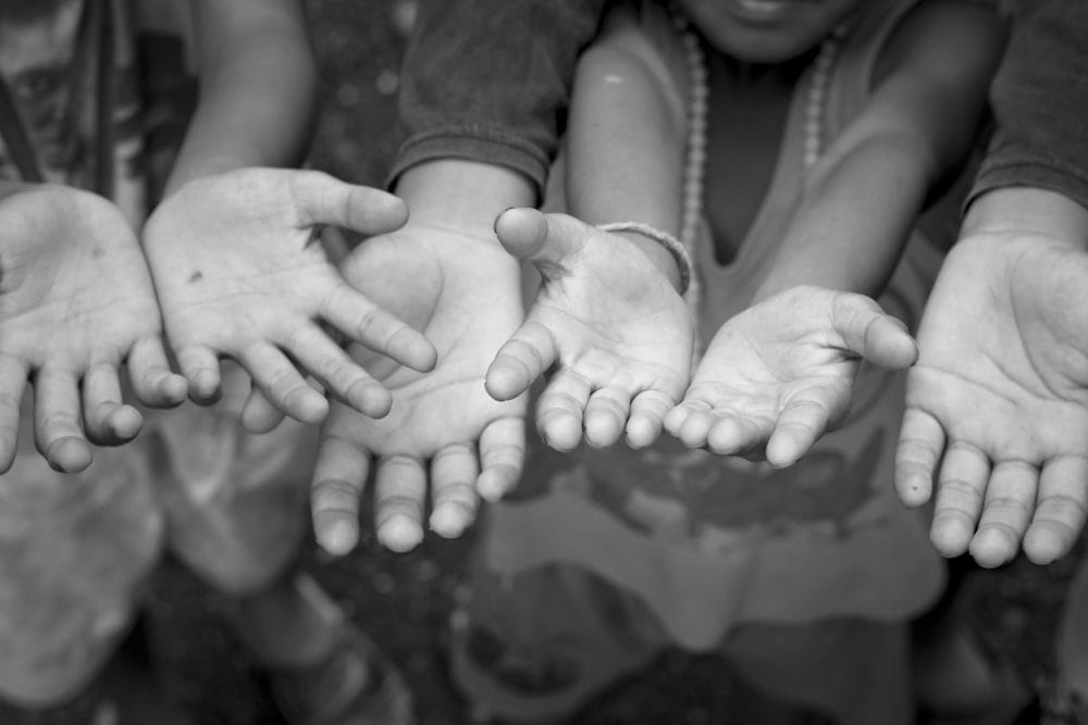 Children Raising hands beg for some food.