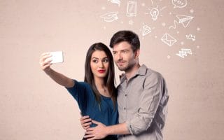 A married couple taking photos to share on social media