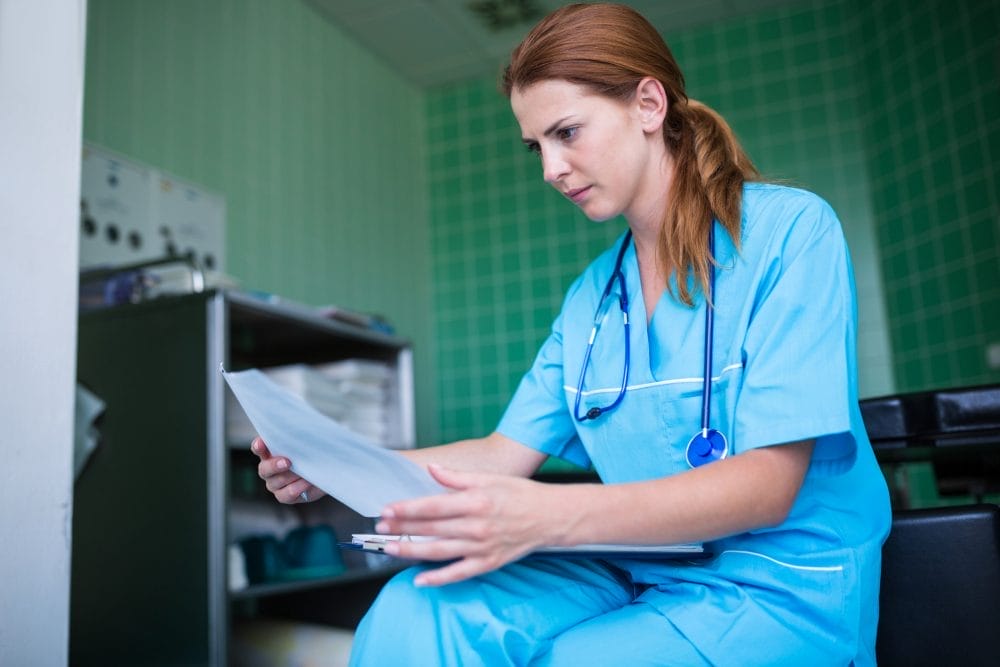Emergency room nurse reading a paper