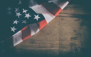 American flag close up on wood desk