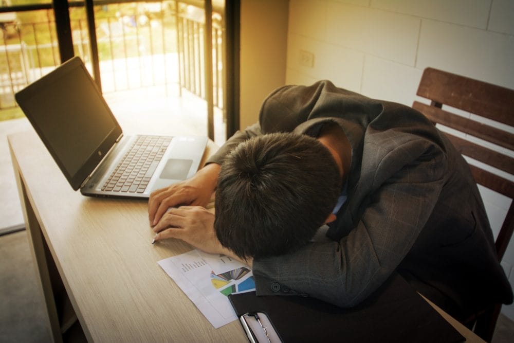 stressed business man on wood table