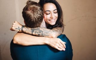 Beautiful, young couple hugging indoors