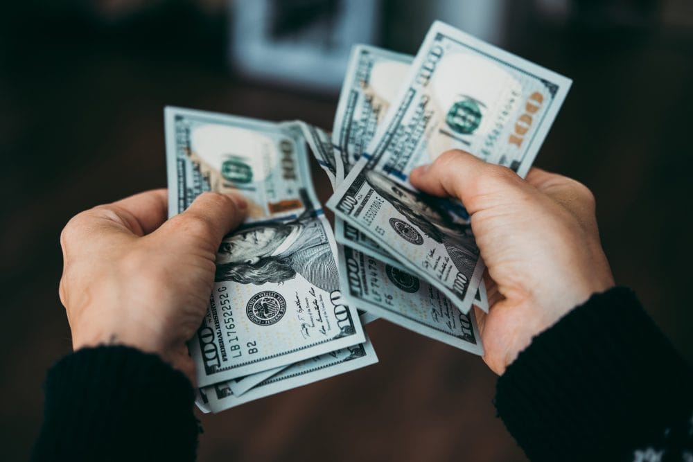 Someone holding cash, fighting their old money trauma