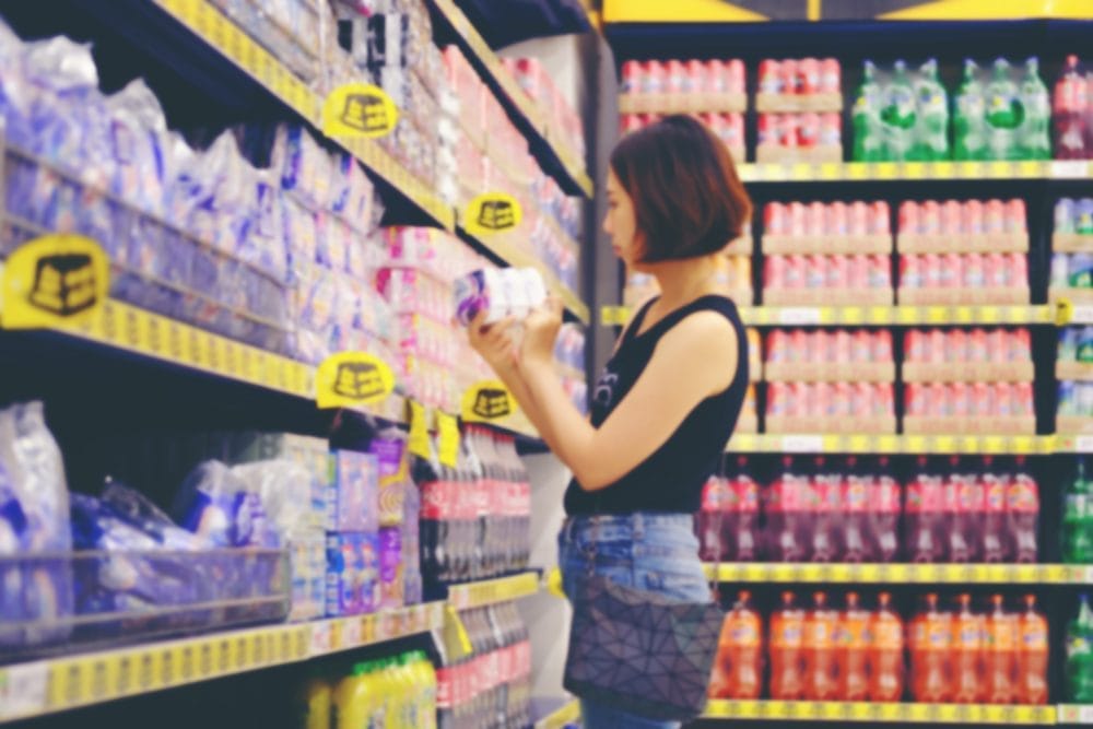 Blurry photo of a young woman shopping at the grocery store