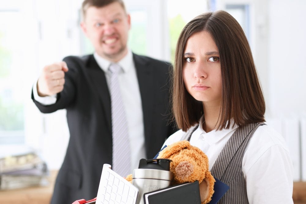 Angry yelling boss pointing at employees as they to exit