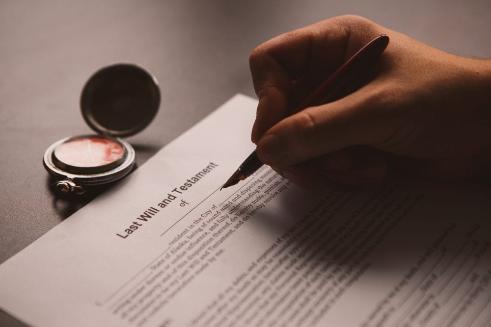 Someone signing their last will and testament