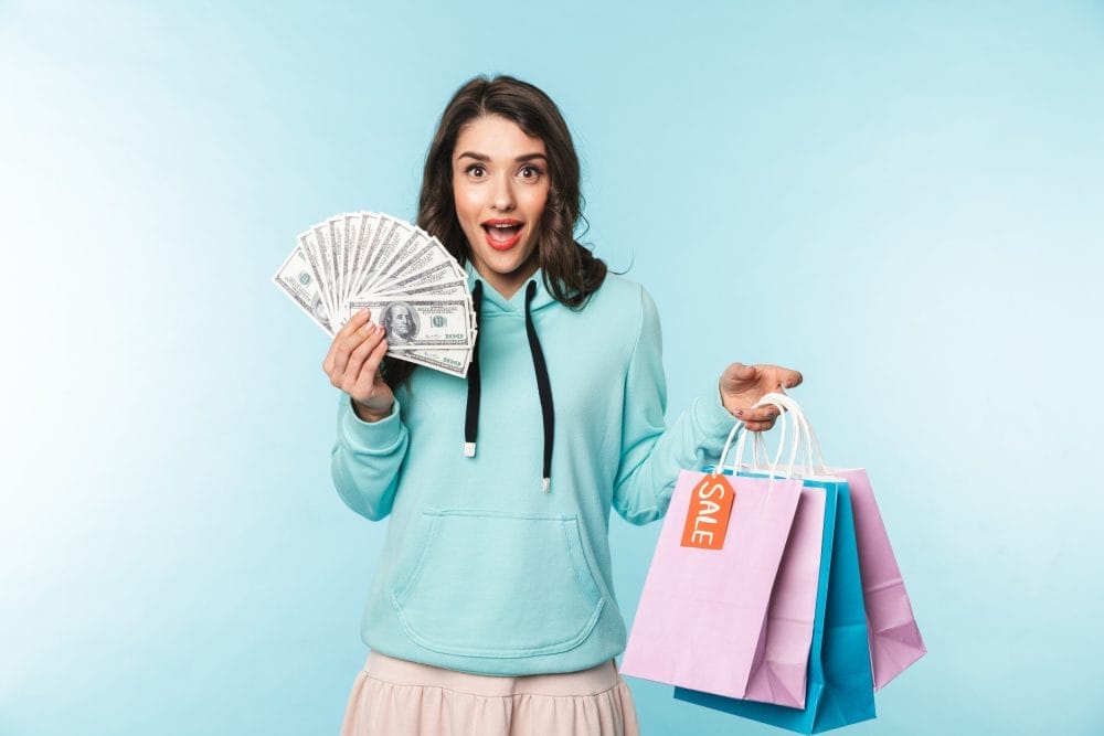 A woman holding shopping bags who has a problem with overspending