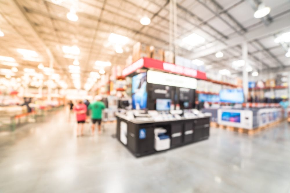 A blurry image of Cotsco, where people buy many items and gas for their cars