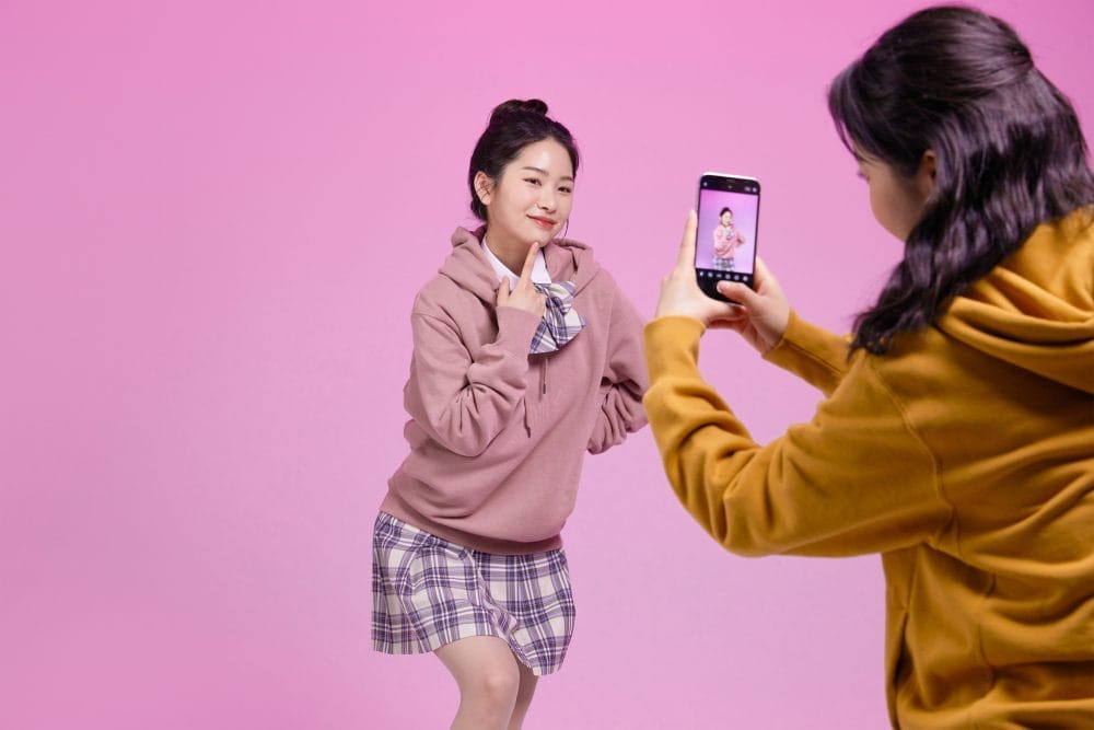 A woman posing as she is in a TikTok video