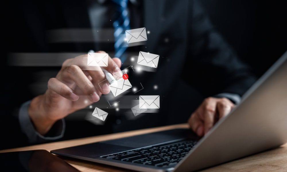 Someone sending an email, which may come across as passive-aggressive