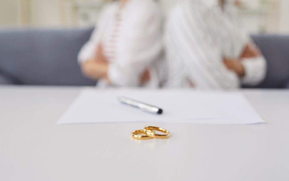 A couple getting divorced with their rings on a table