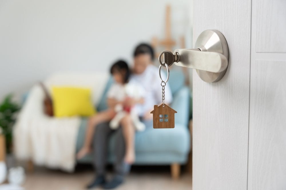 A father and child in an apartment with the door open, persumably because of a landlord