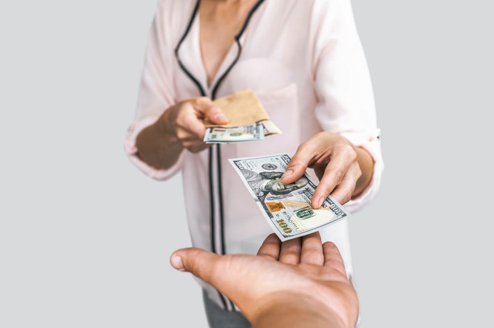 A woman lending money to family