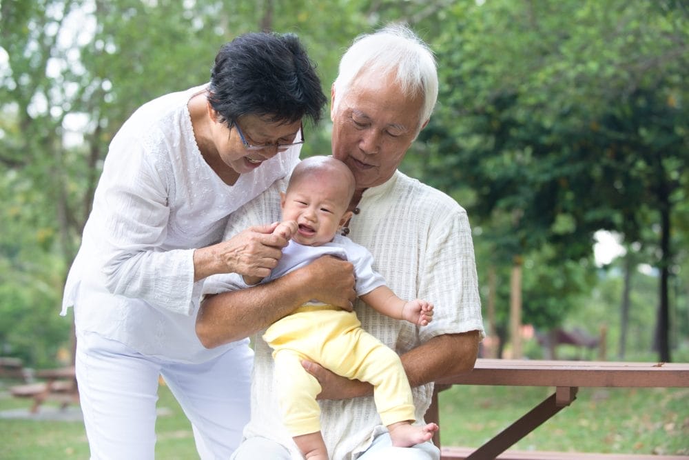 A pair of grandparents babysitting their grandchild