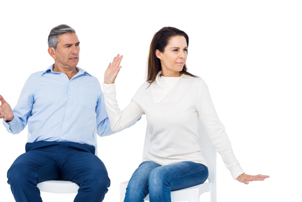 A woman looking away from a man who is being condescending