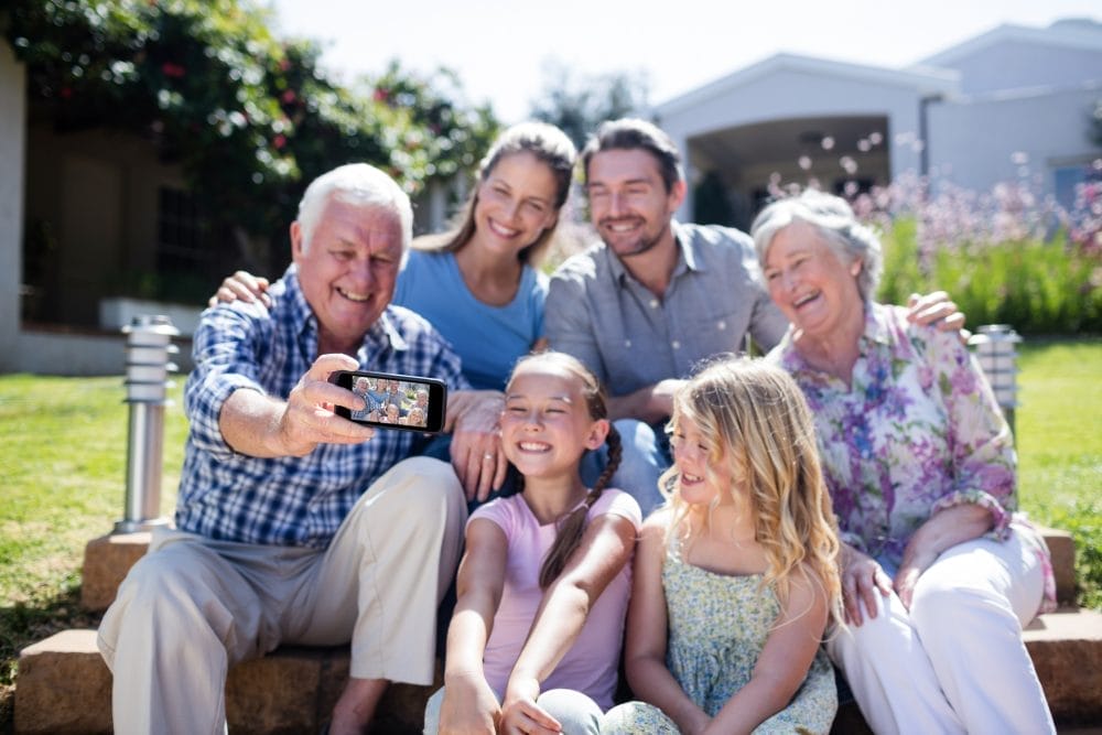 A family, including adult children, taking a photo together