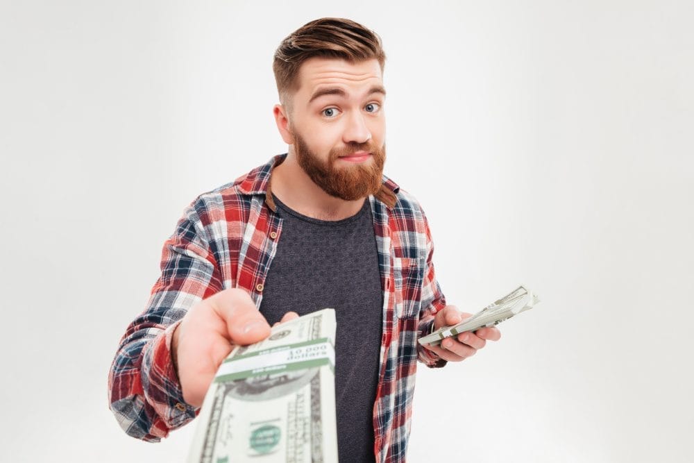 A man offering a stack of cash, following family rules about money