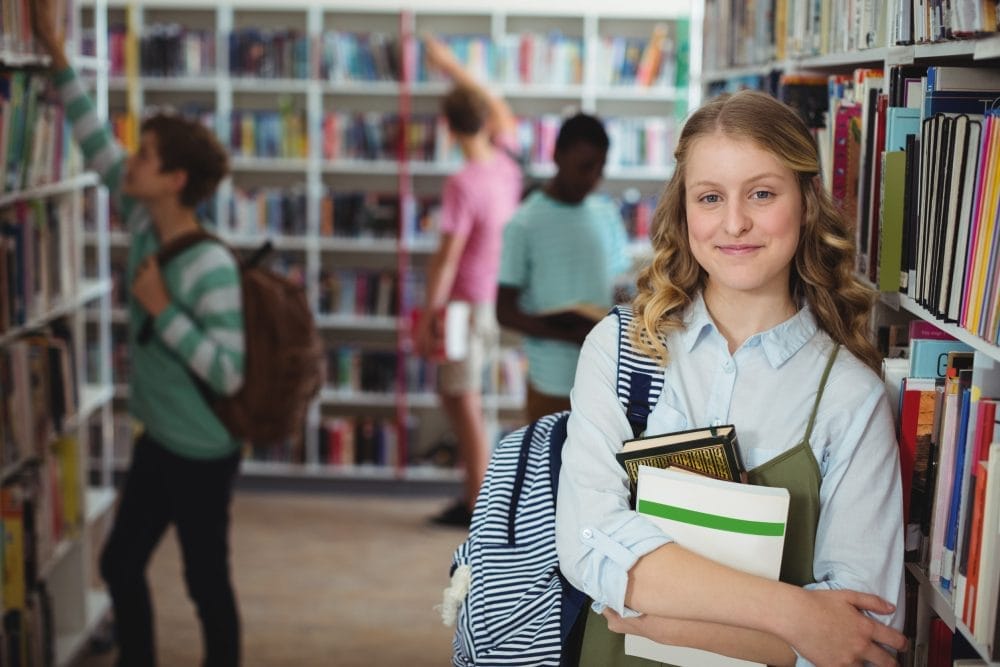 A young female student in a school library