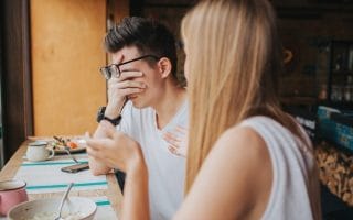 A man feeling judged in a conversation with a woman