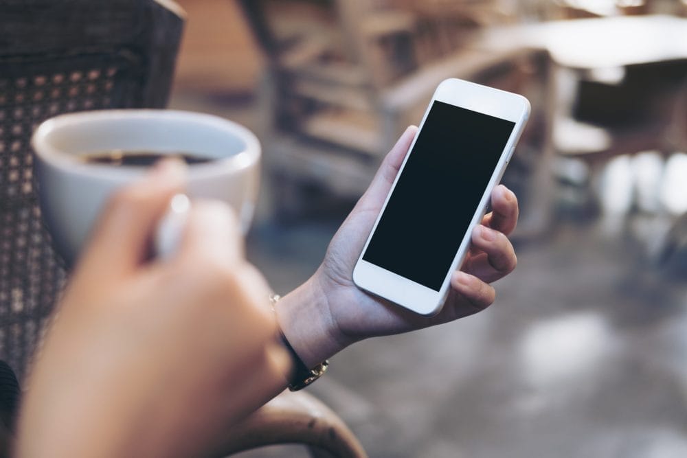 Someone checking another person's phone because they do not trust them