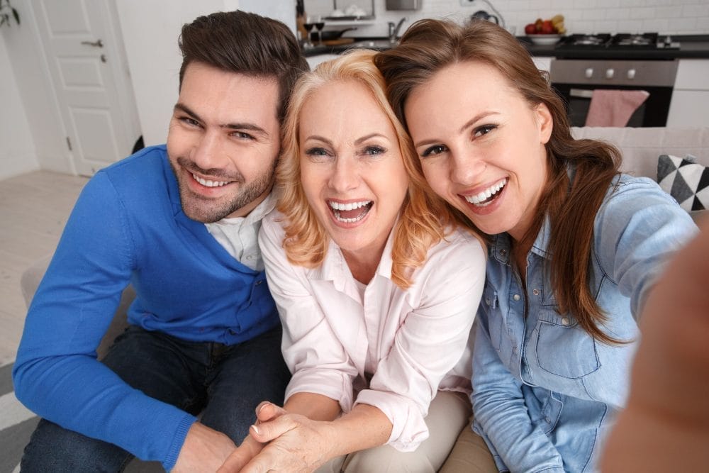 A parent with her adult children, who are happy and thanking her