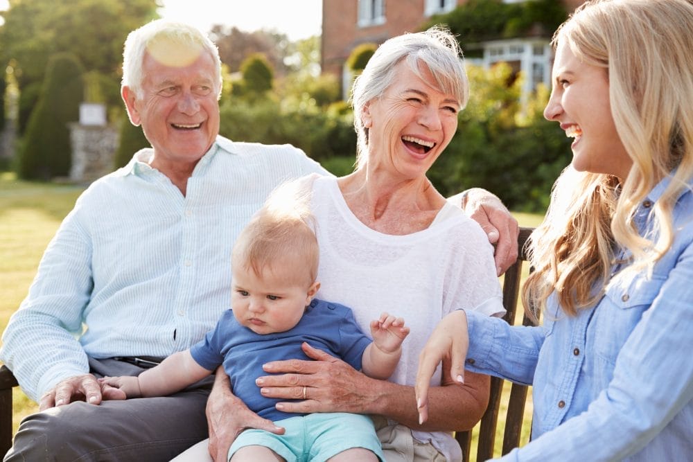 Granparents holding their grandbaby