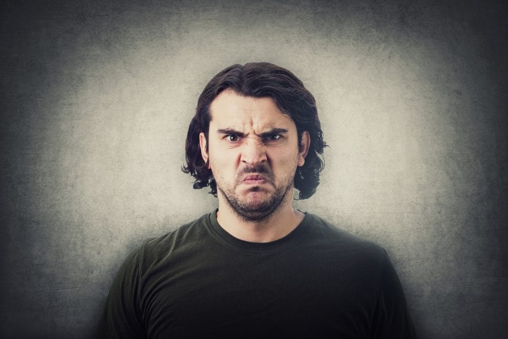 An angry man looking defensive