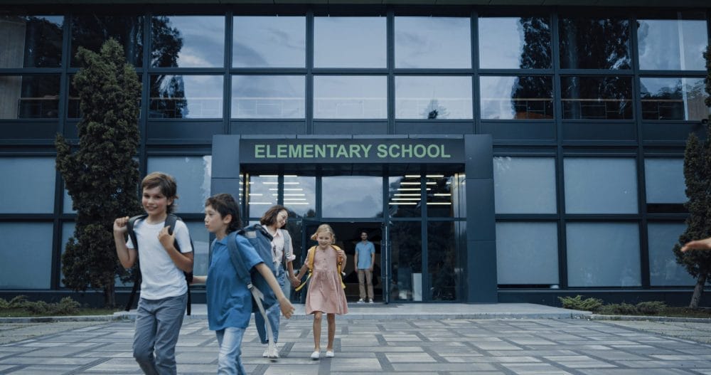 A group of students going into one of the many schools that teach inaccurate facts.