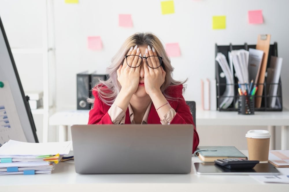 An office worker feeling the stress of modern social norms