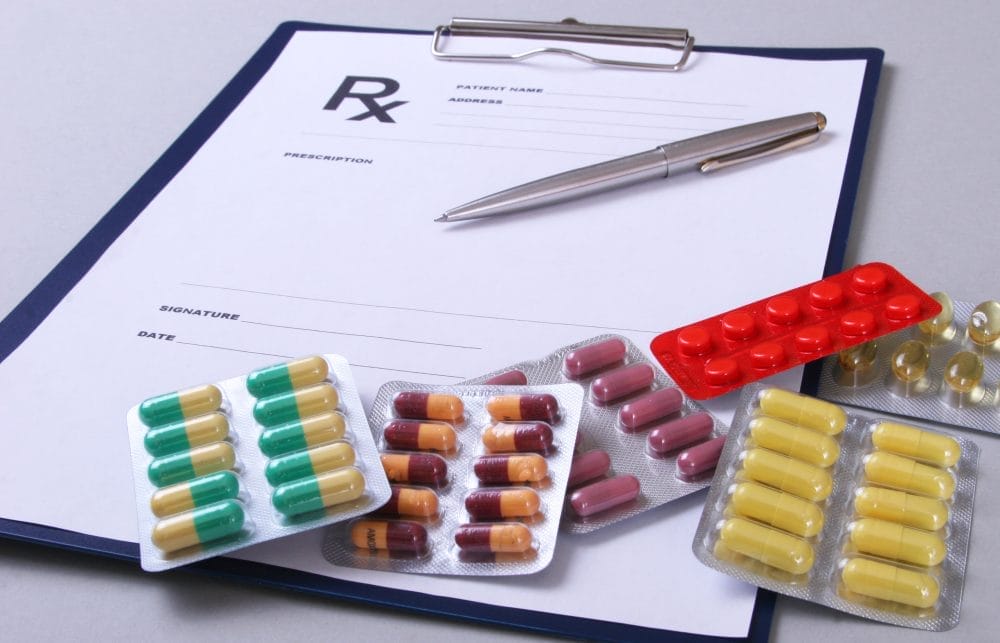 Prescription drugs and a doctor's clipboard