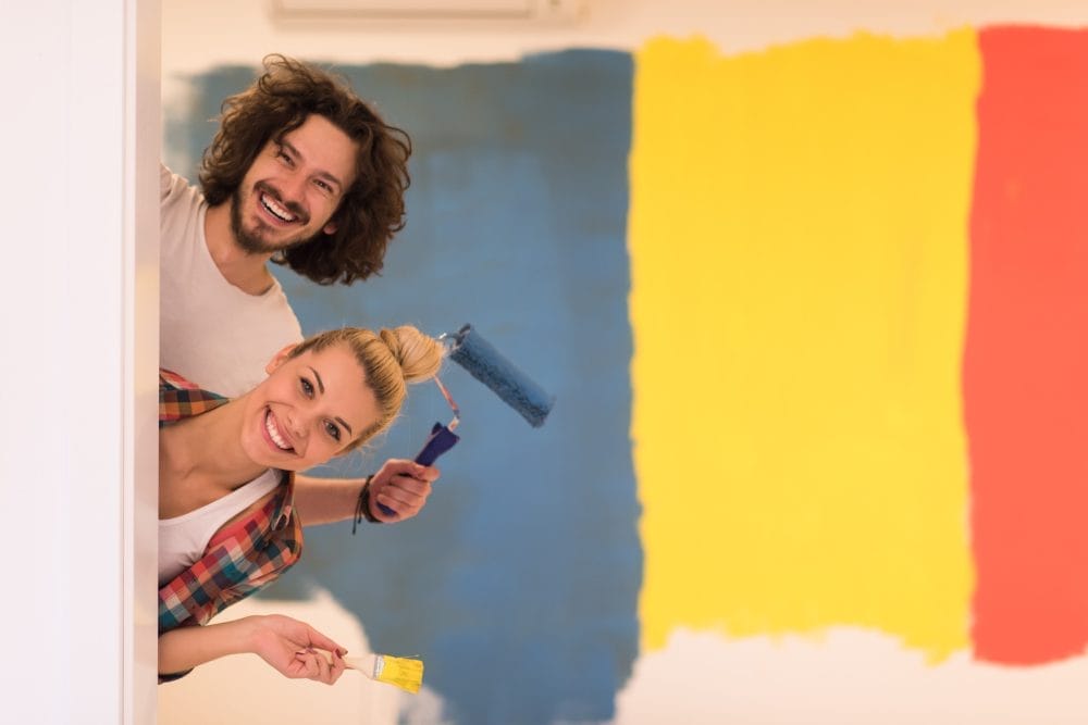A couple painting the inside of their home