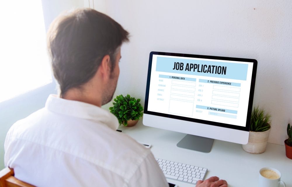 A man filing out a job application online