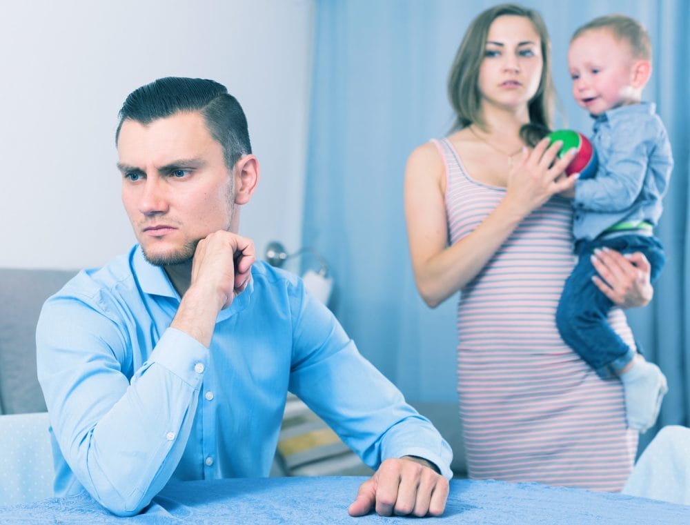 A father practicing silence while his family looks on