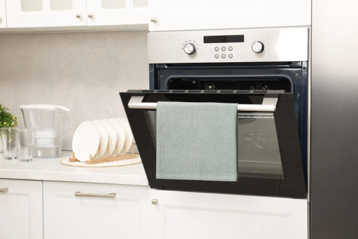 If You Have a Towel on Your Oven Door, Remove It Now—Experts Say It’s a Fire Risk